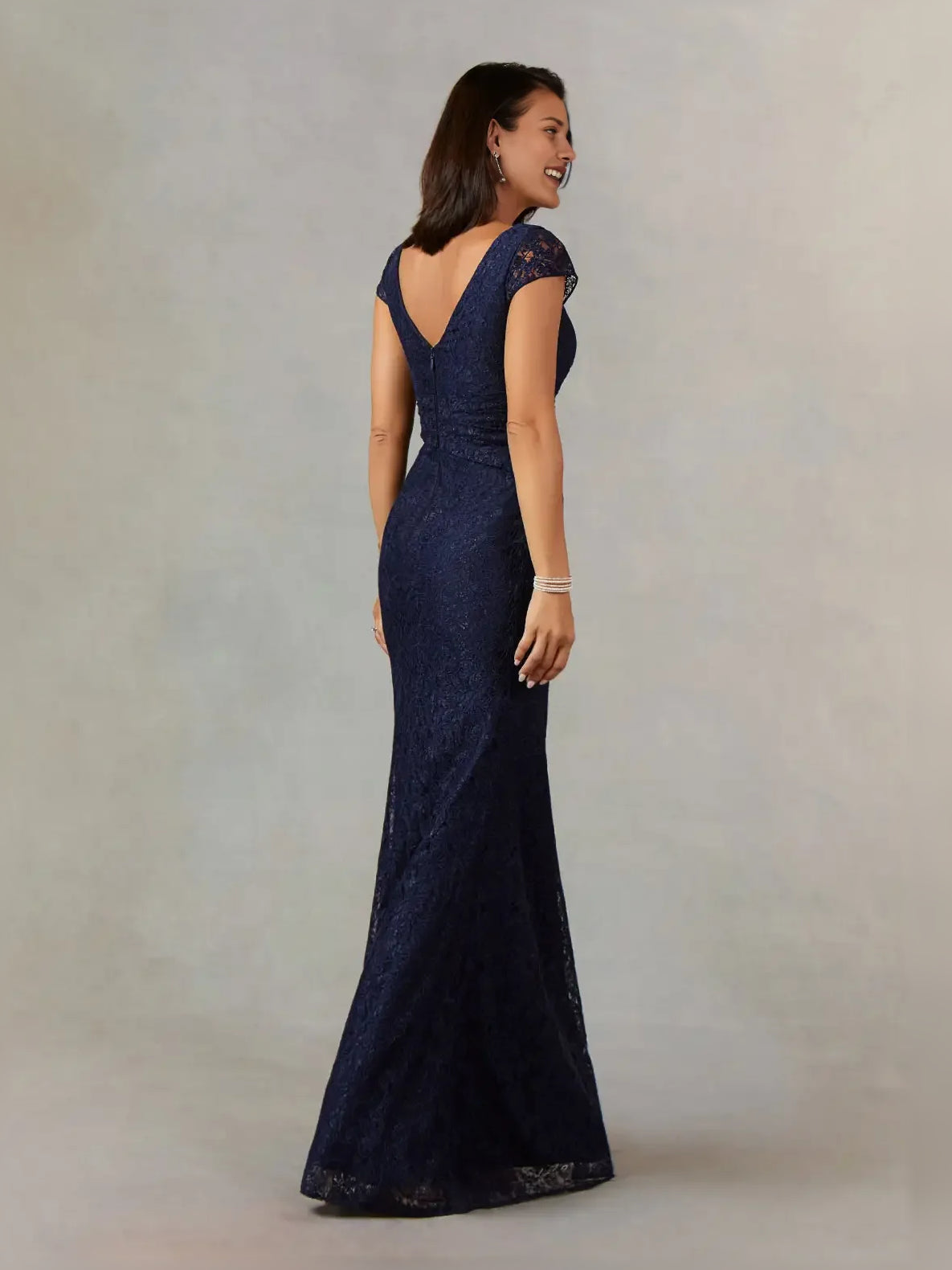 Dark navy textured mermaid gown with V-neck, cap sleeves, and front slit, side view