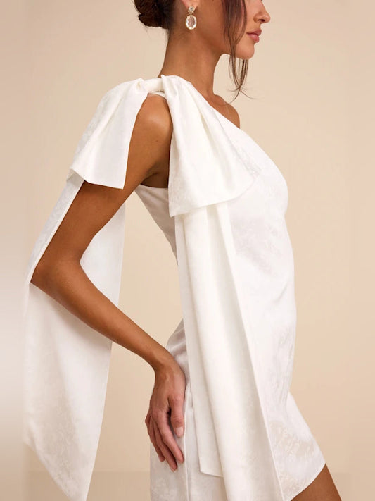 White one-shoulder mini satin dress with long draped sash at back