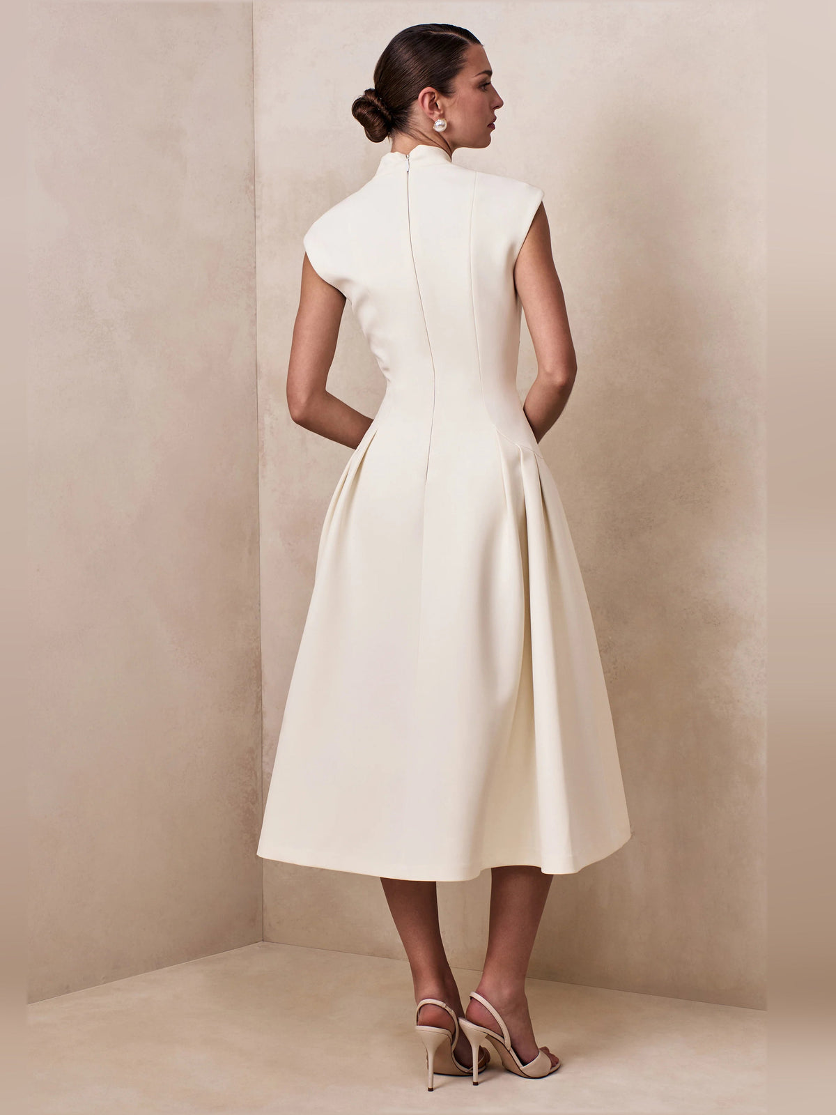 Cream V-neck sleeveless midi dress back view with pleated flared skirt