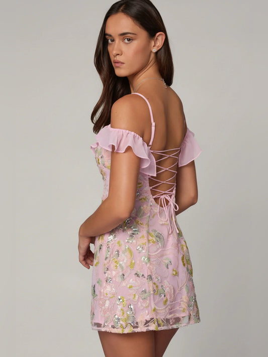 Pink A-line mini dress with ruffled off-shoulder front and lace-up crisscross back