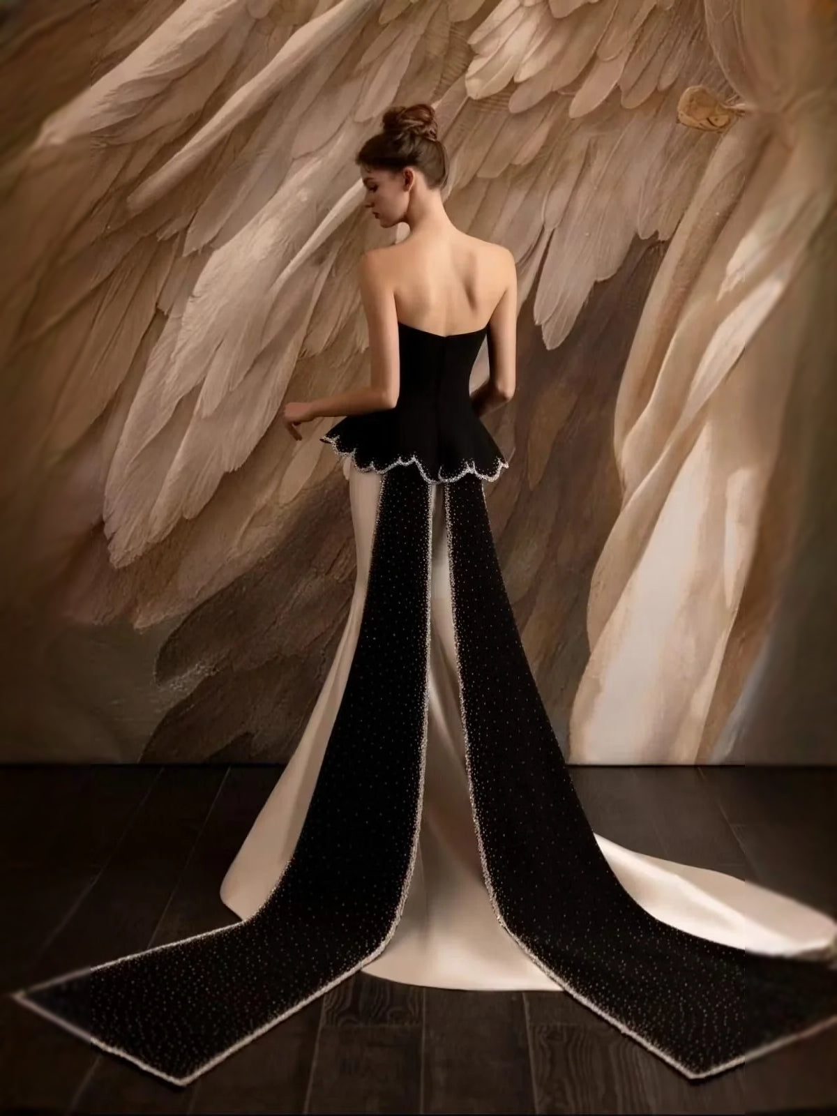 Strapless mermaid formal dress with black corset top, scalloped peplum, cream skirt.