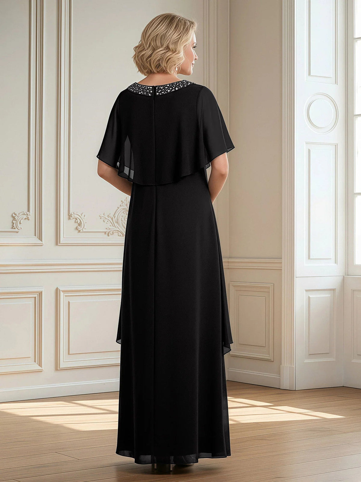 Black floor-length sheath dress with draped chiffon cape sleeves and beaded back neckline
