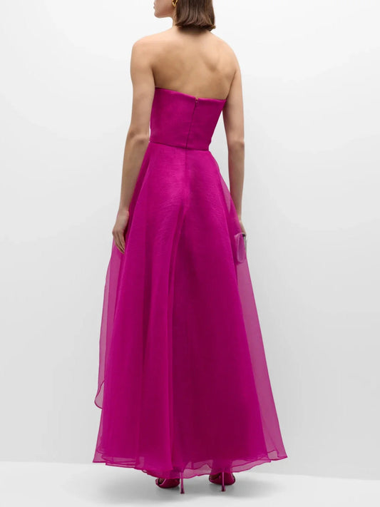 Fuchsia strapless A-line formal dress, back view with structured bodice and layered hem.