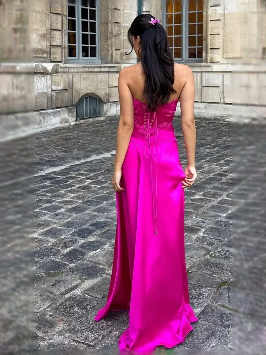 Hot pink satin prom dress from back view, square neckline, thin straps, A-line hem.
