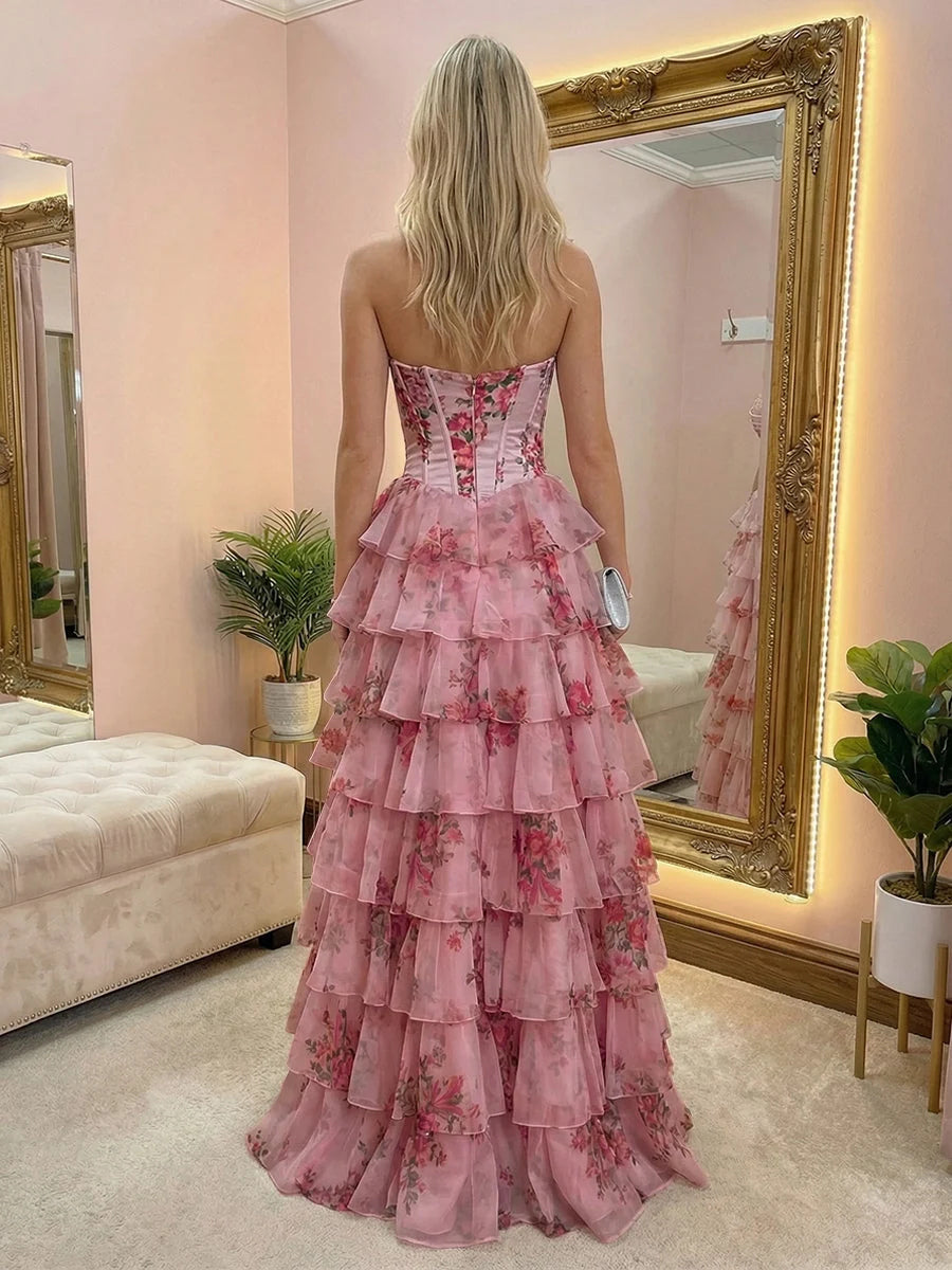 Back view of blush corset tiered tulle prom dress with floral ruffle tiers
