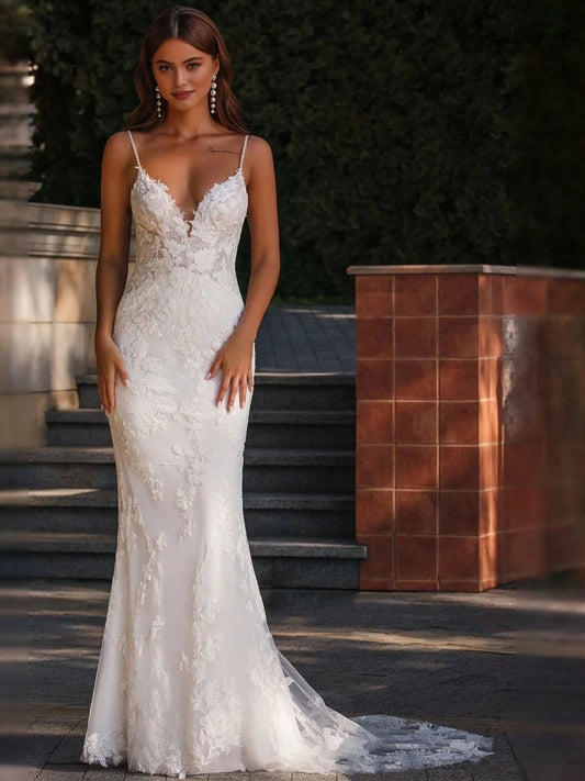White lace mermaid wedding dress with thin straps, V-neck, floral applique, and tulle hem