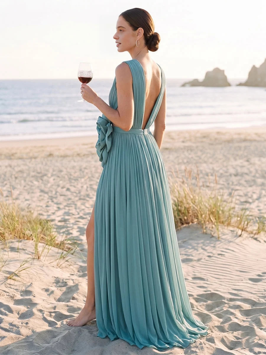 Teal pleated V-neck chiffon gown with open back and flowing side slit