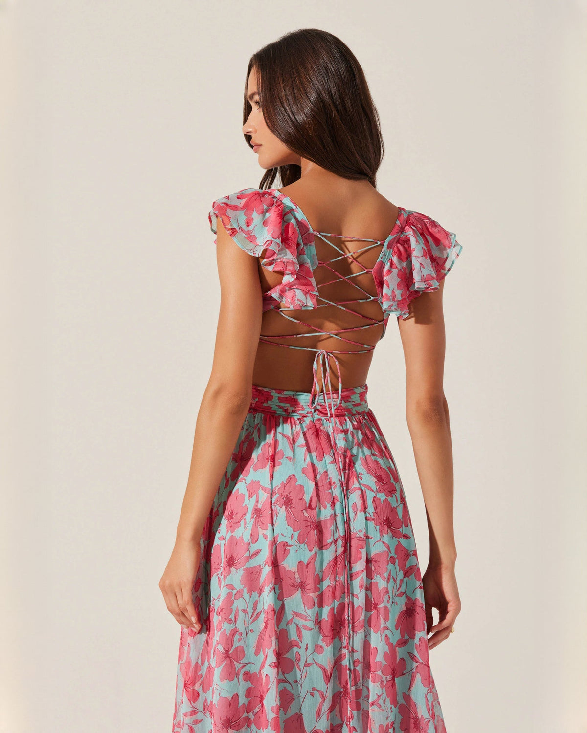 Floral sleeveless maxi dress with crisscross lace-up back, pink and teal print