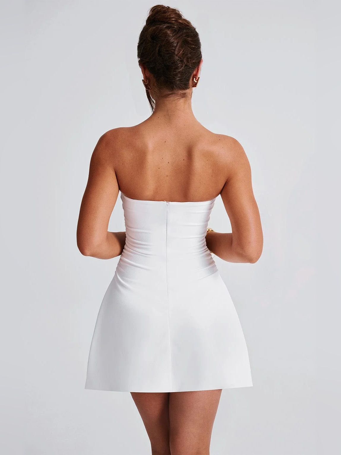 Ivory strapless mini homecoming dress, back view with fitted bodice and flared skirt