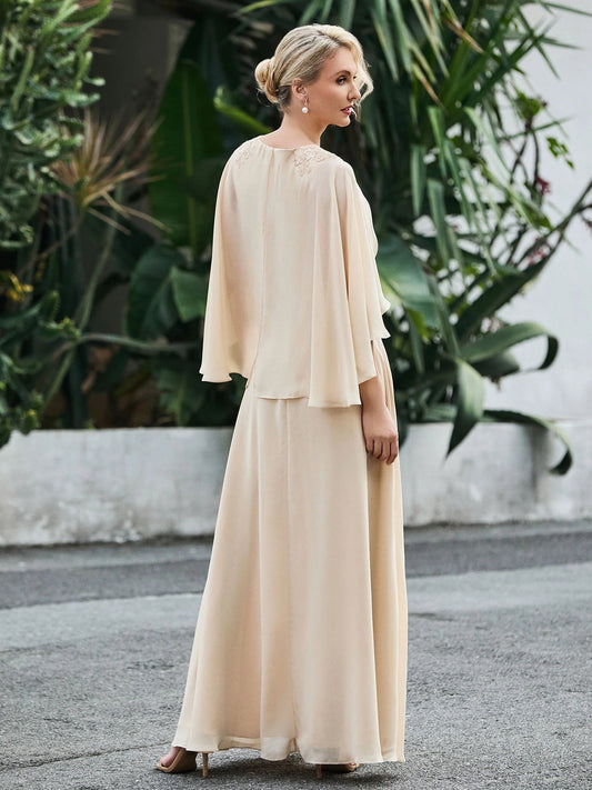 Champagne chiffon A-line dress with beaded waist and flowing cape sleeves, floor length.