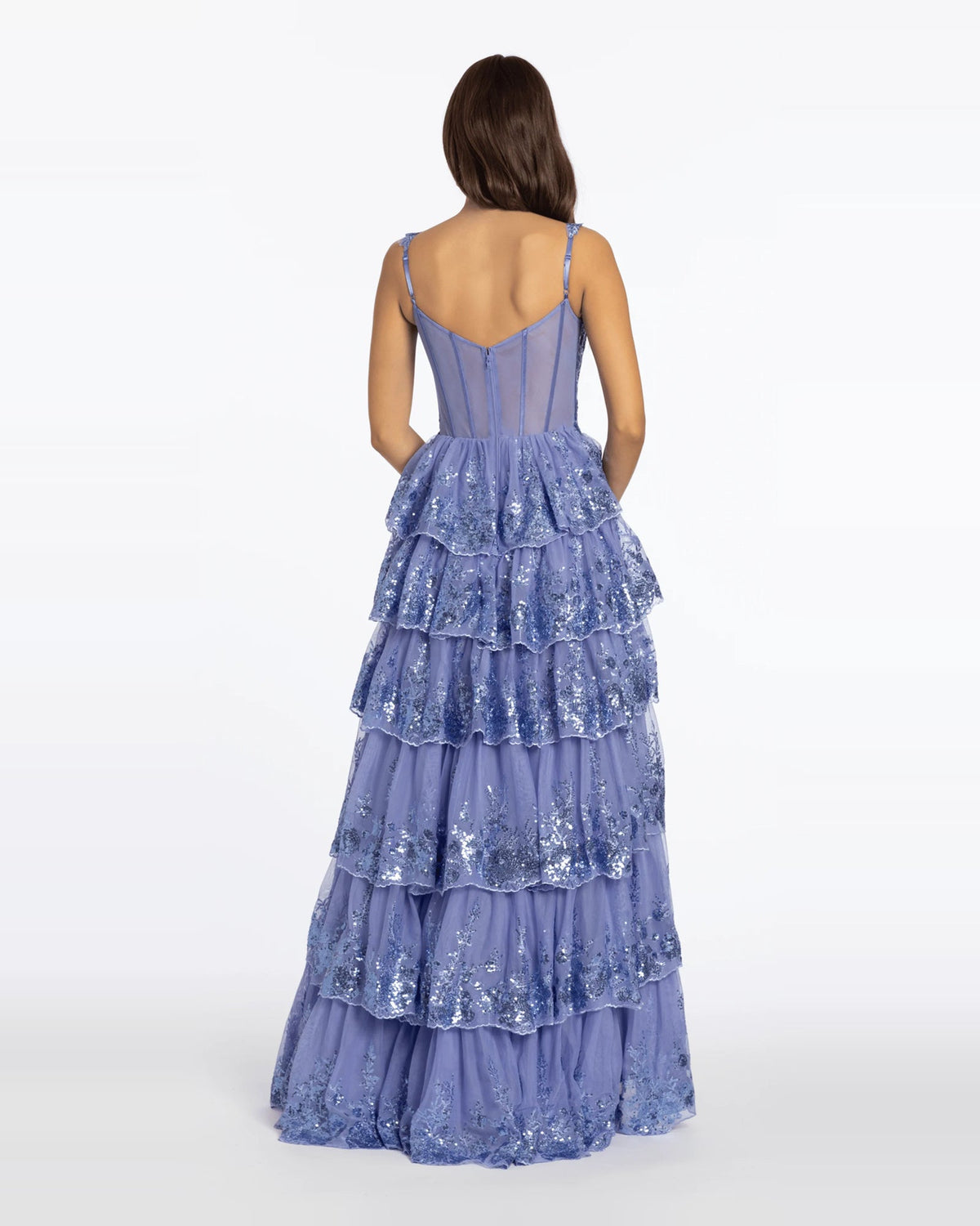 Back view of sparkly periwinkle-blue tiered ball-gown prom dress with spaghetti straps