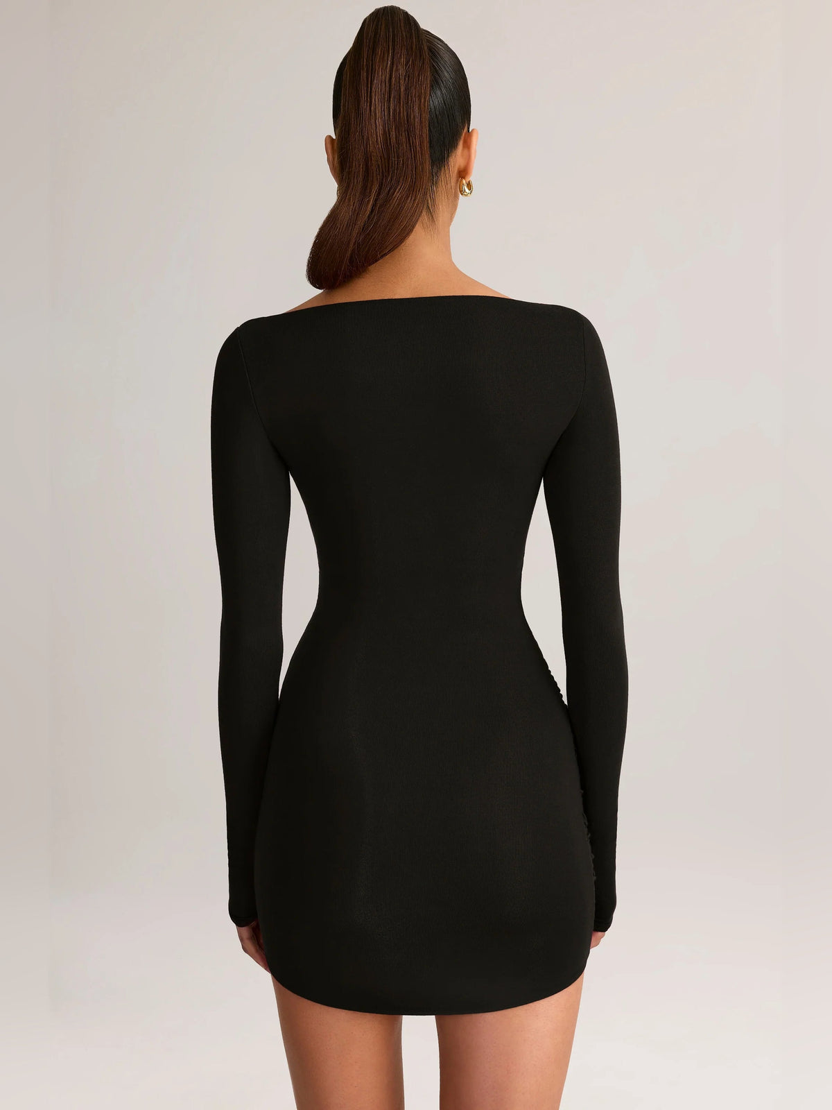 Black draped long-sleeve mini dress with boat-neck back and fitted silhouette