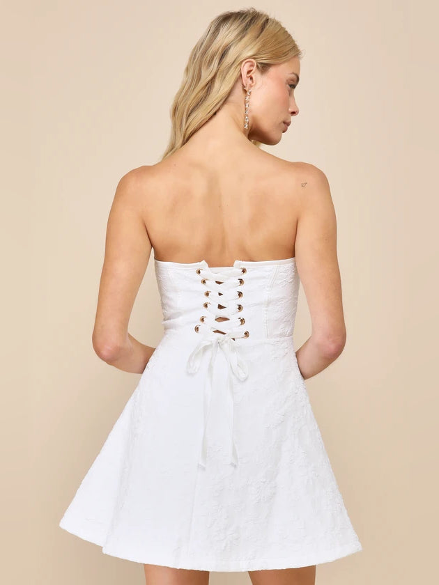 White strapless mini dress with crisscross back lacing and ribbon tie