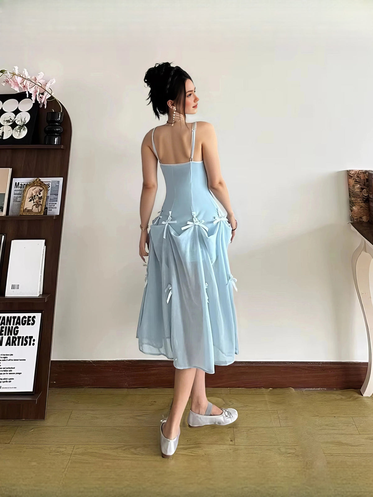 Light blue A-line maxi prom dress, scoop-back style with spaghetti straps and bow details