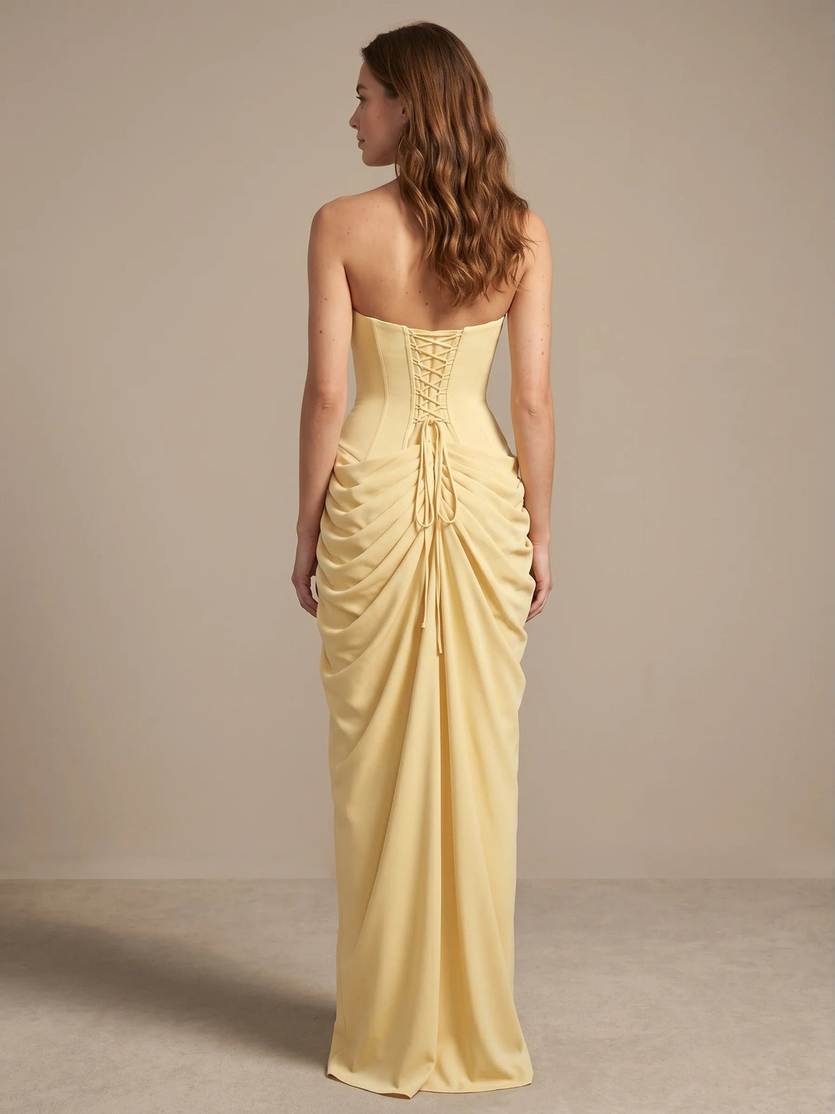 Pale yellow strapless corset-style bodice mermaid maxi dress with ruched drape