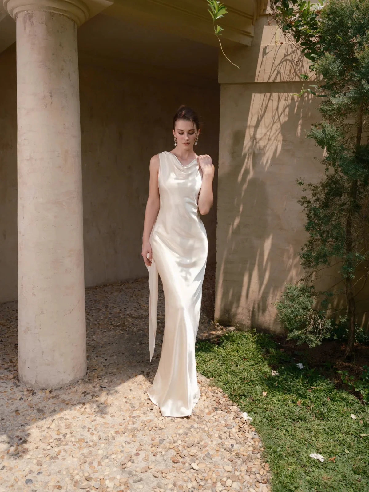 Ivory satin draped cowl-neck sheath wedding dress with sleeveless bodice and long skirt