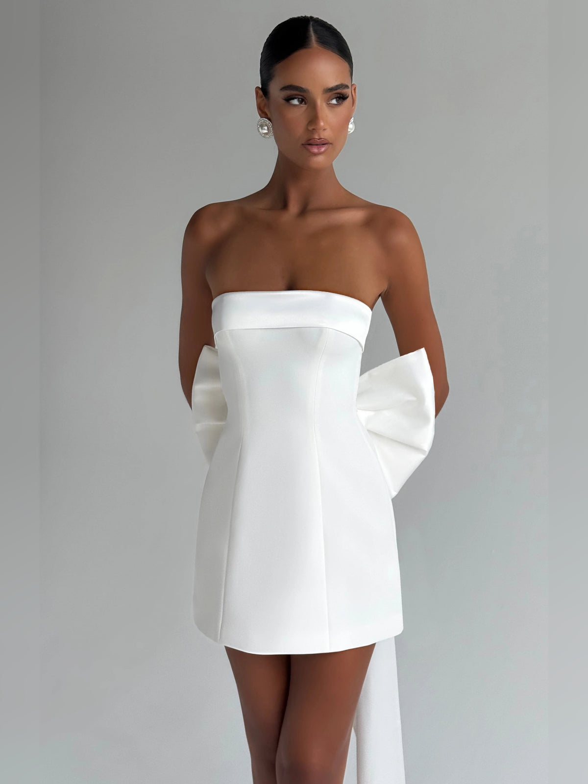 Ivory strapless mini dress with straight neckline and asymmetrical bow drape
