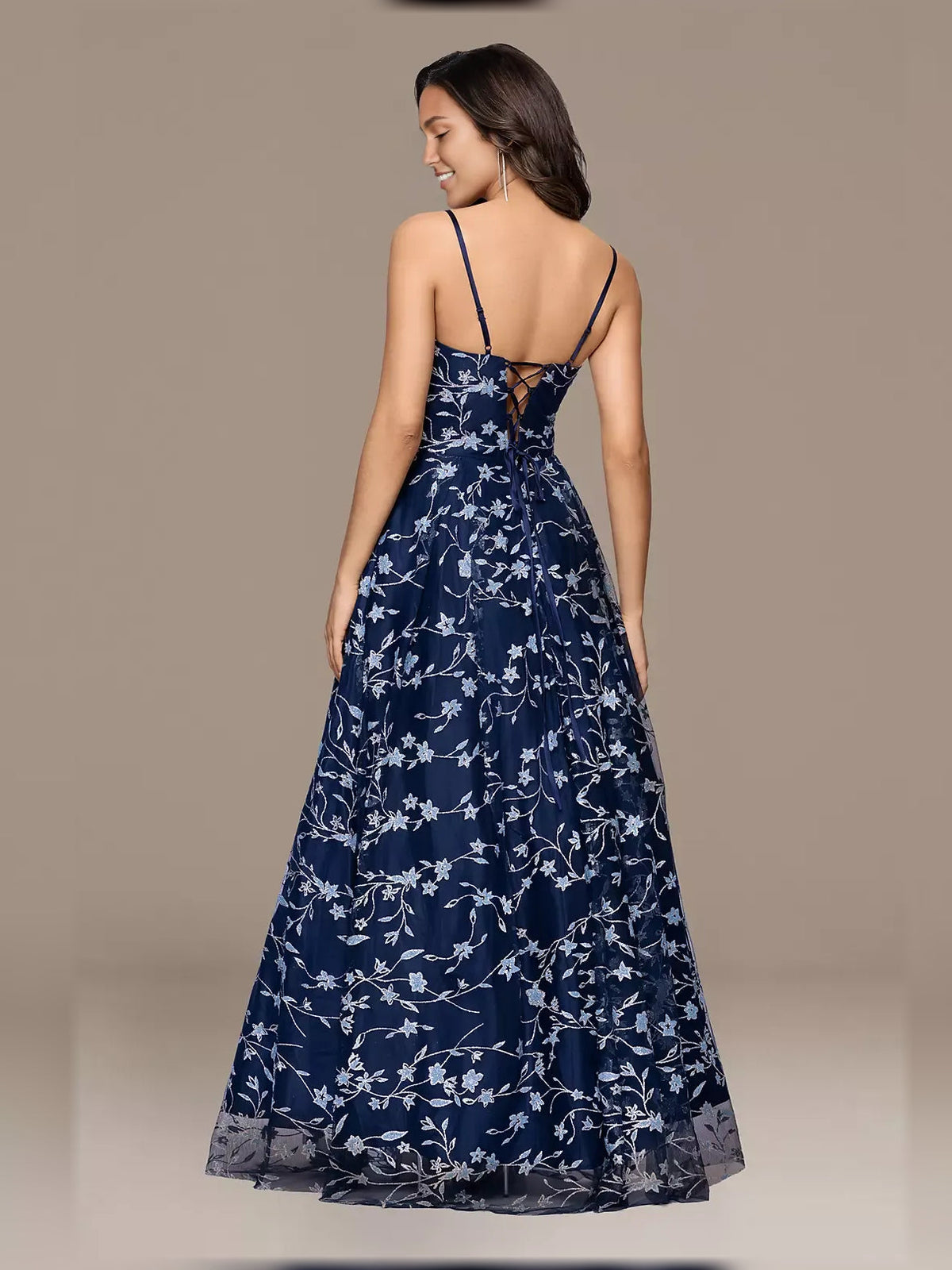 Back view navy floral print formal dress with thin straps and tiered skirt
