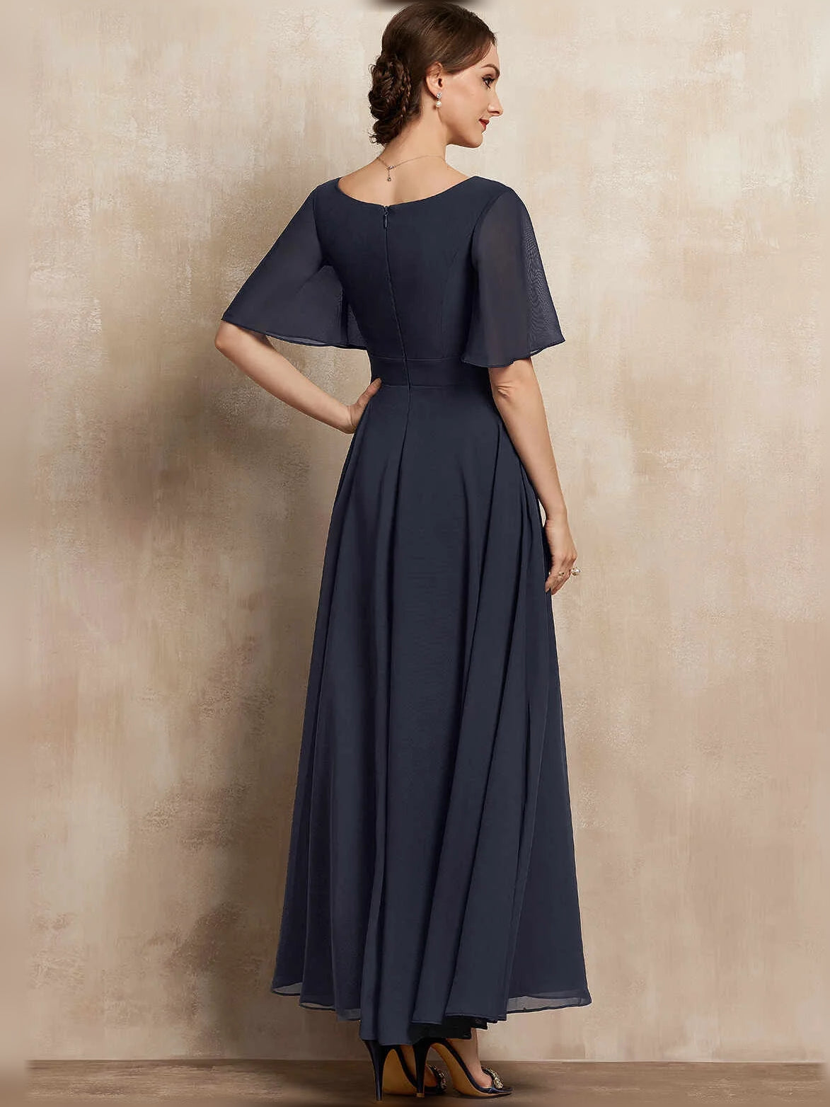 Navy chiffon A-line maxi dress with V-neck, pleated skirt, flutter sleeves, and beaded waist detail