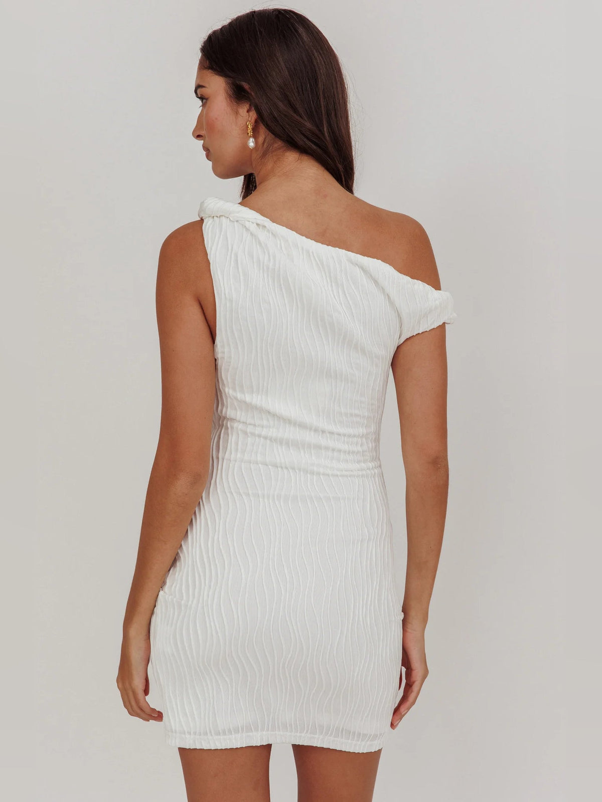 White one-shoulder mini dress, ruched back view with gathered shoulder detail