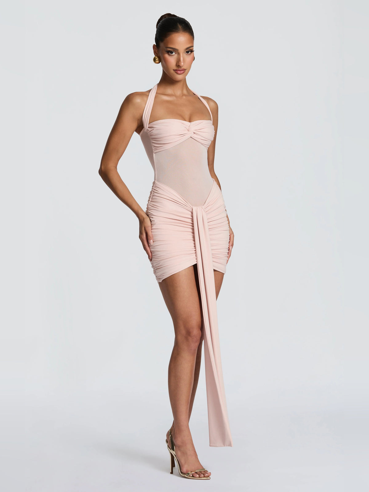 Blush mini halter dress with ruched side drape and long sash trailing down