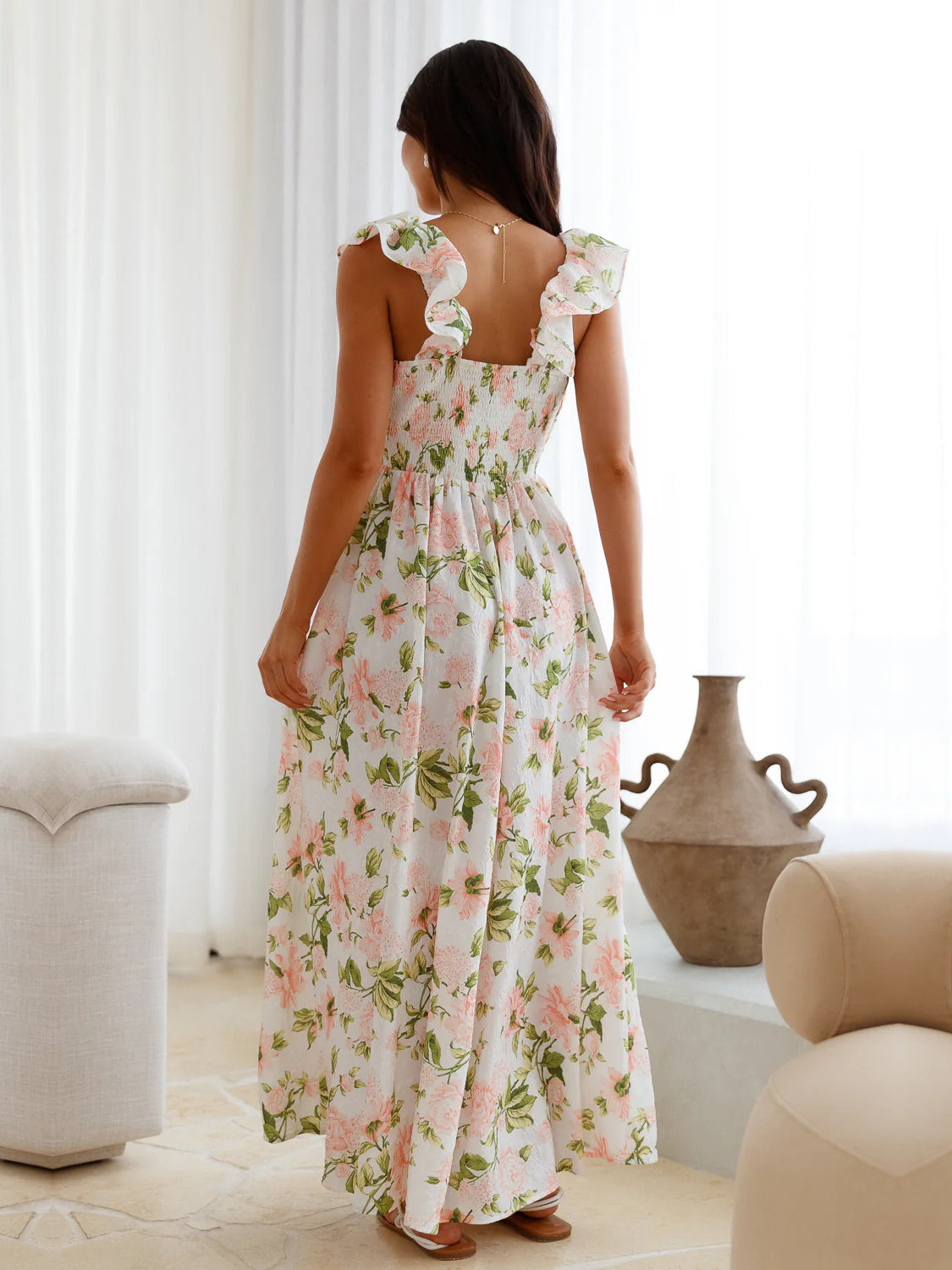 White a-line maxi formal dress with floral print, full-length back view