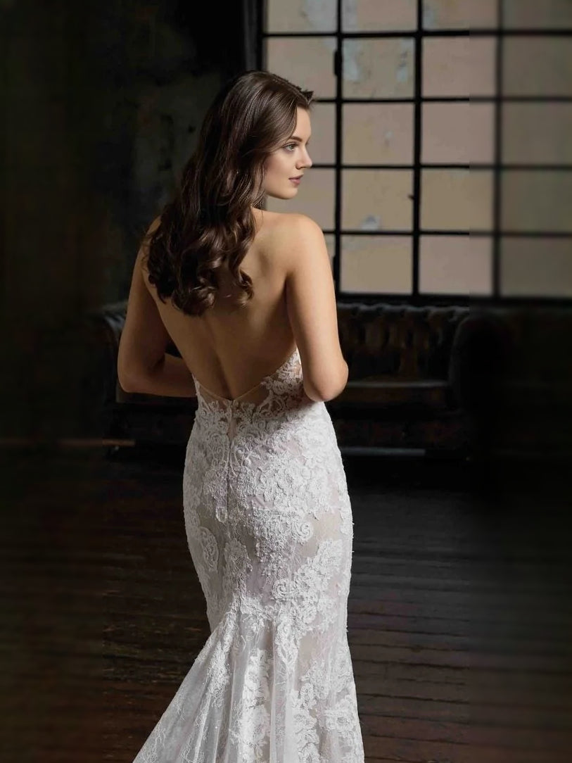 Ivory lace halter-neck mermaid wedding dress with low back and fitted silhouette