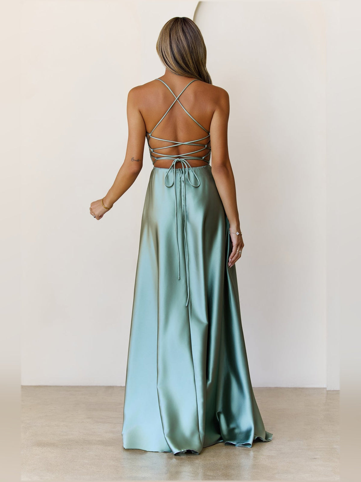Sage a-line maxi formal dress with skirt slit, full-length back view