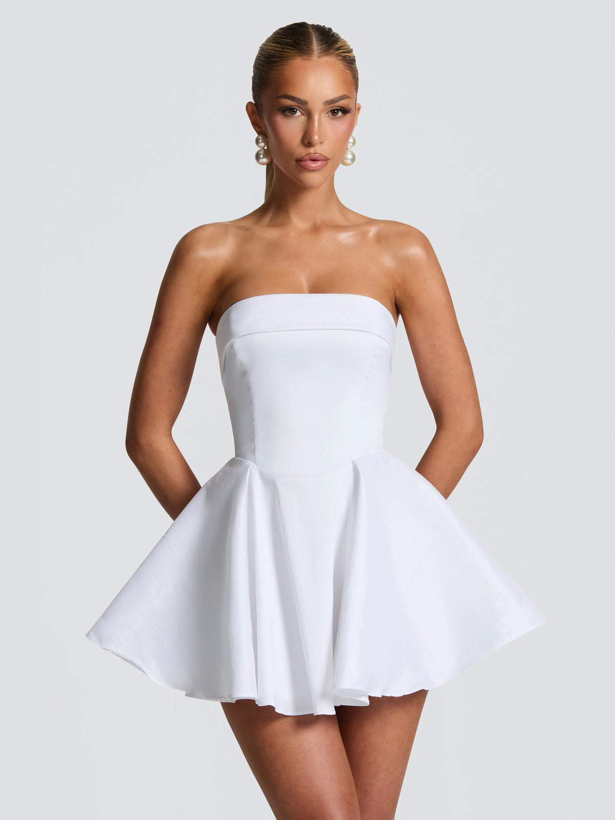 Ivory strapless mini dress with smooth bandeau top and flared gathered skirt
