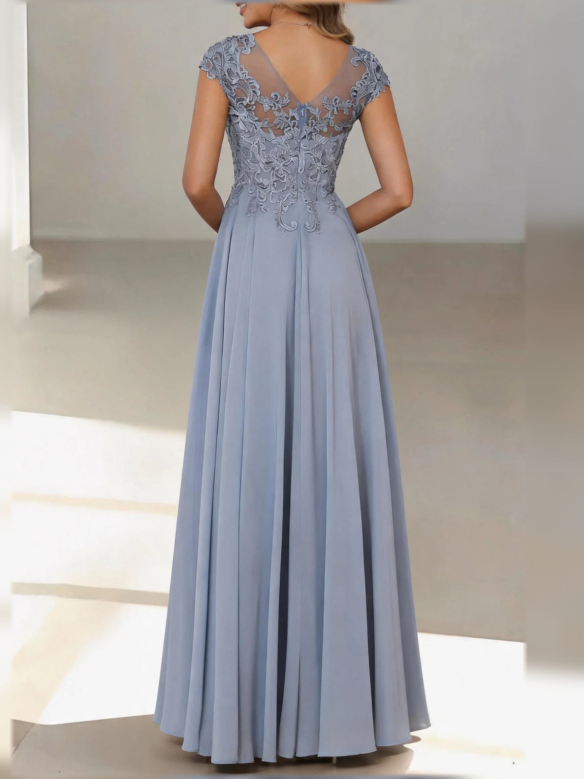 Dusty blue lace bodice open-back dress with cap sleeves and pleated skirt