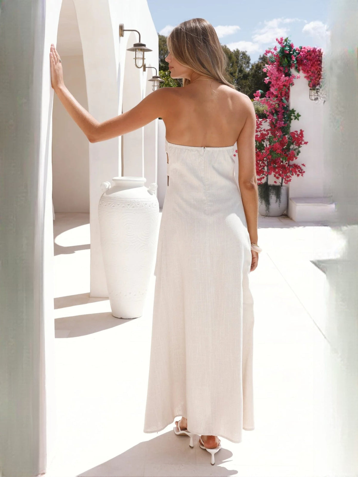 Ivory a-line maxi formal dress with skirt slit, full-length back view