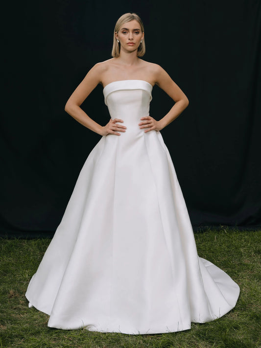Ivory strapless A-line wedding dress with subtle bodice seams, floor-length satin