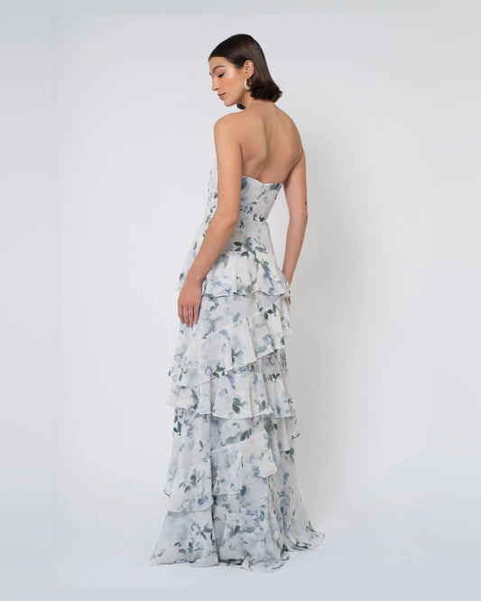 Blue floral A-line maxi formal dress shown from back, strapless with tiered ruffles
