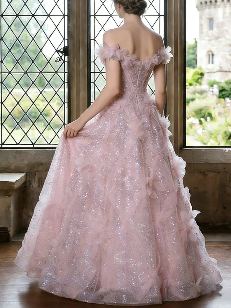 Back view of blush pink off-shoulder sequin ball gown with layered tulle skirt