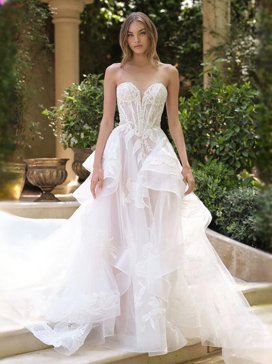 Ivory corset-style wedding dress with floral lace bodice and layered tulle ruffle A-line skirt