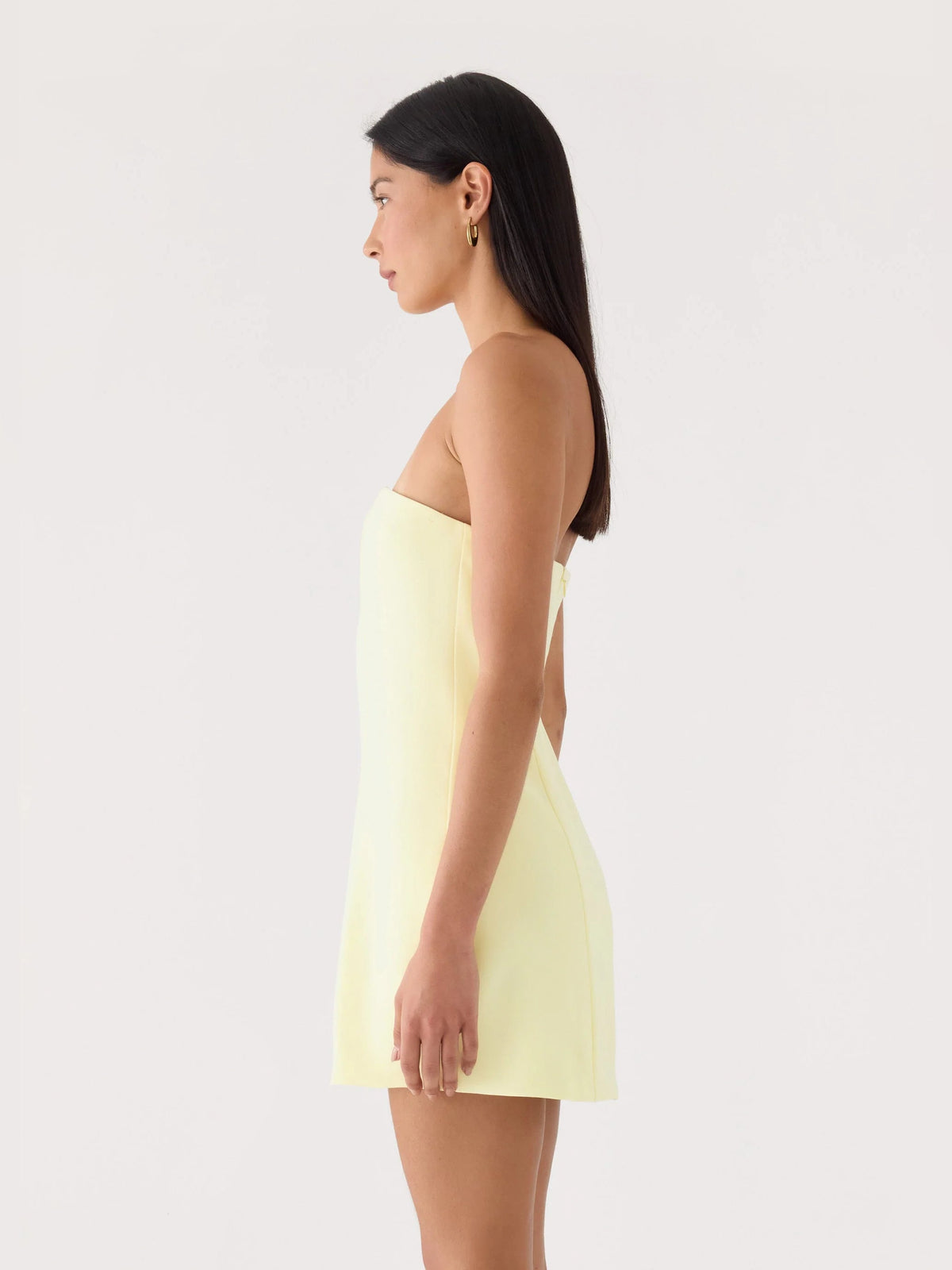 Yellow strapless mini dress shown in side view, featuring embroidered floral bodice detail