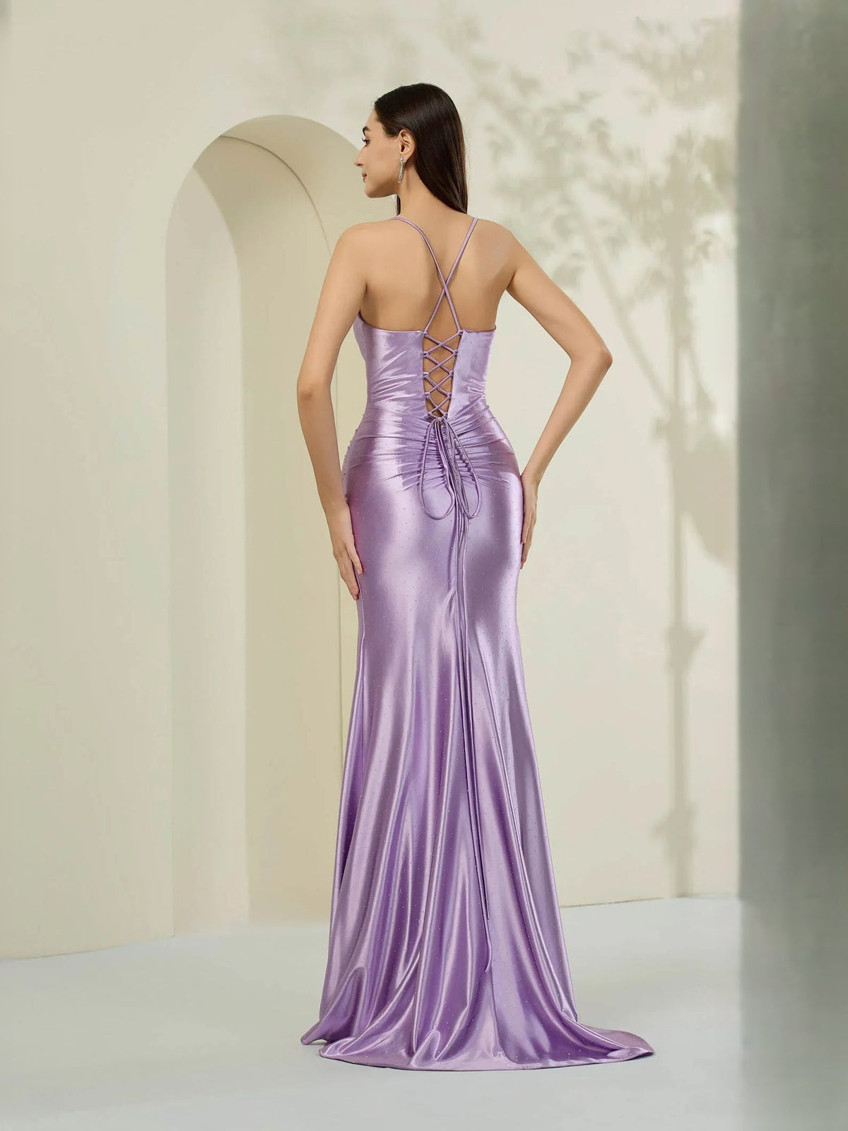 Lilac floor-length gown with open back, crisscross straps, and long front slit