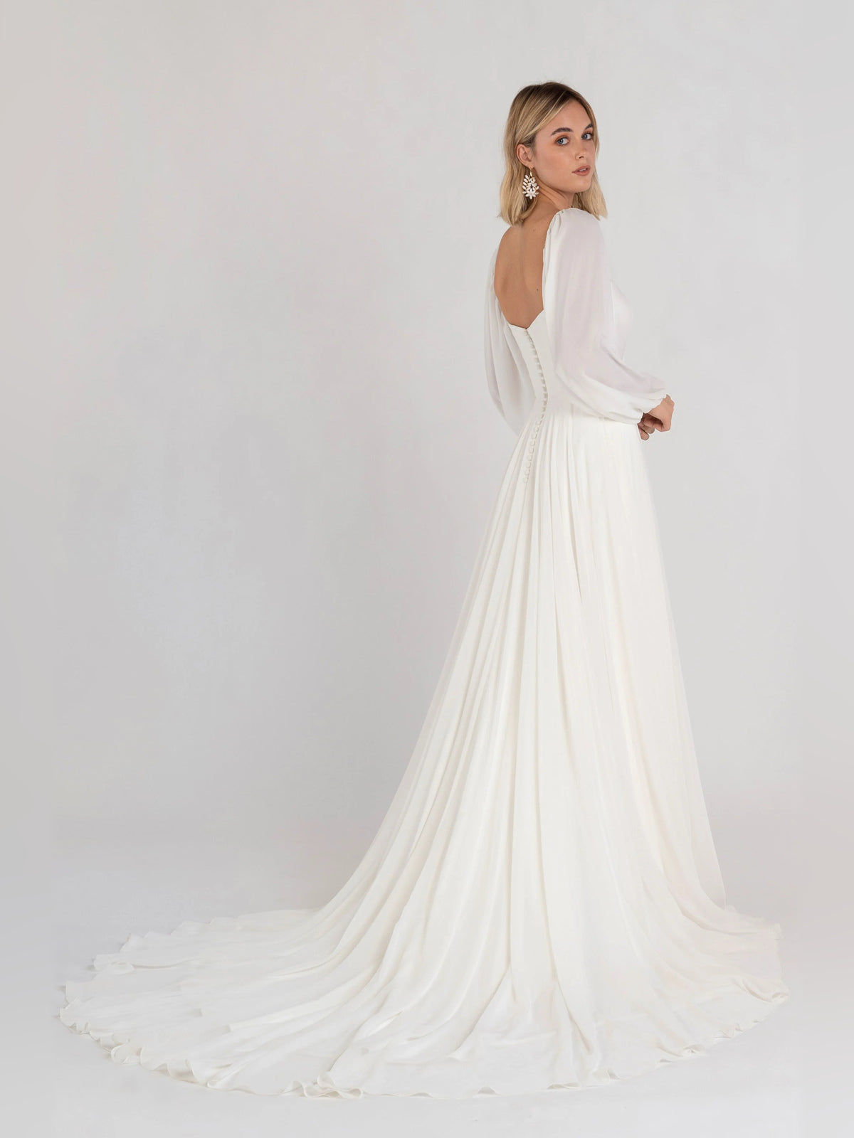 Off-white square-neck A-line formal dress with long puff sleeves, full flowing skirt