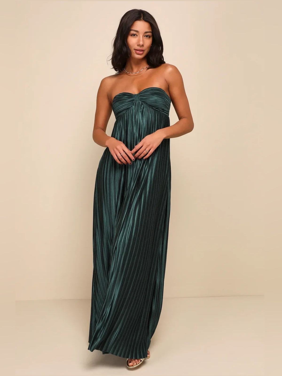 Emerald green strapless satin maxi dress with twisted ruched bodice and pleated lines