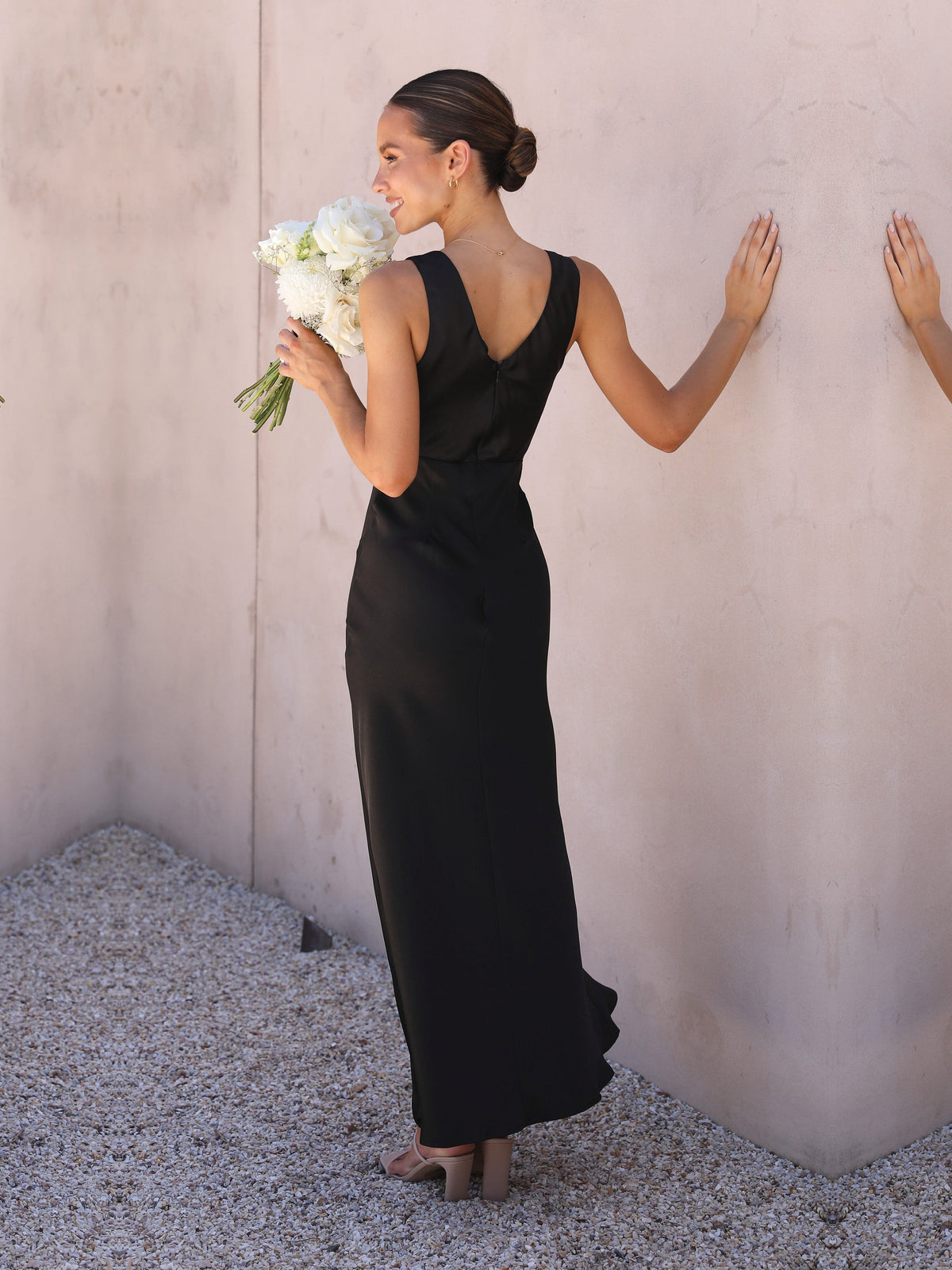 Black sheath maxi formal dress with skirt slit, full-length back view