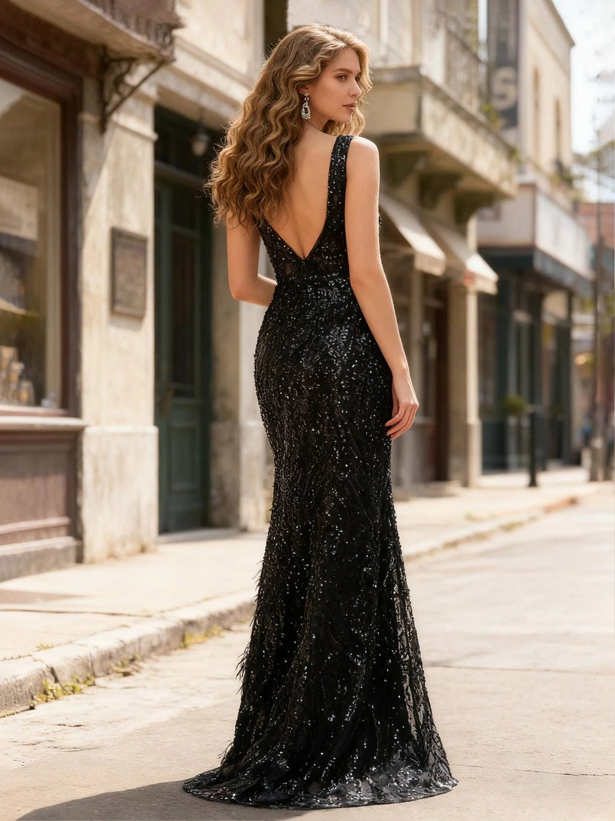 Black V-neck sequin formal gown with open back and floor-length slit