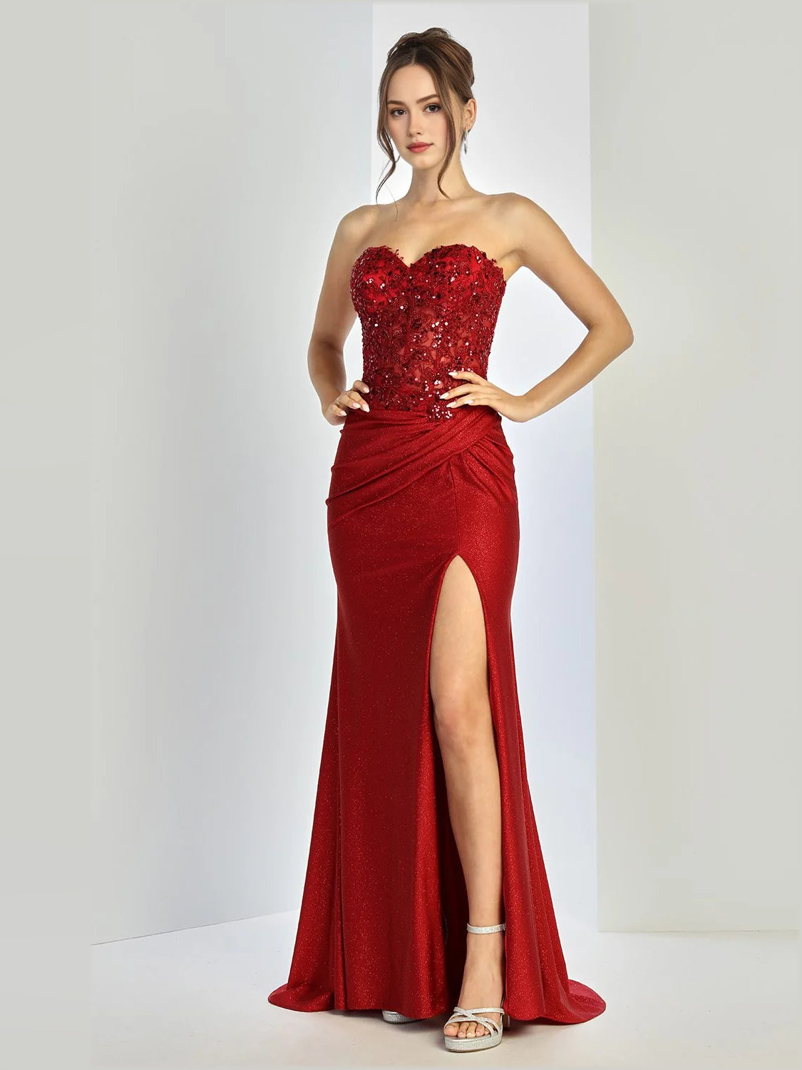 Burgundy strapless mermaid prom dress with jeweled bodice and thigh-high slit