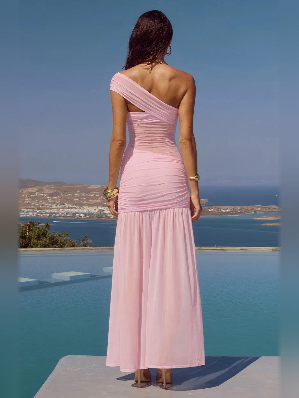 Back view of one-shoulder mini homecoming dress in light mauve with draped straps