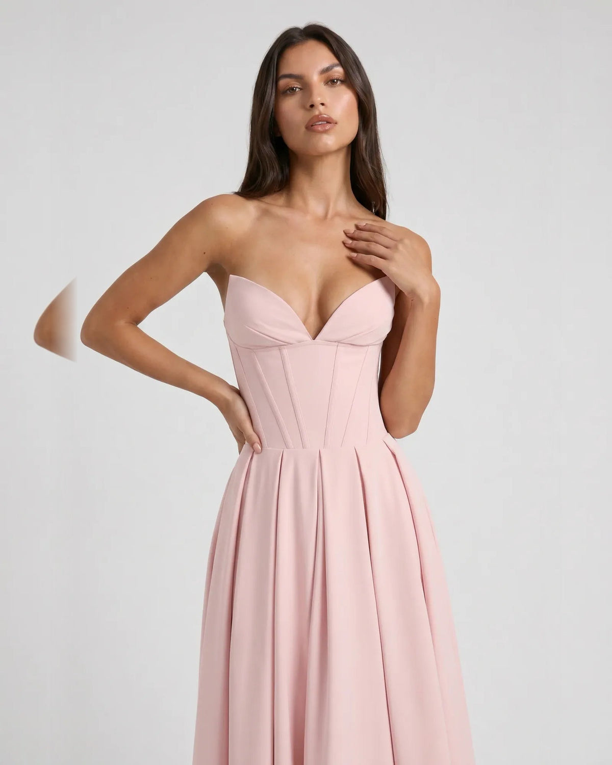 Blush pink strapless sweetheart corset midi dress with structured bodice seams