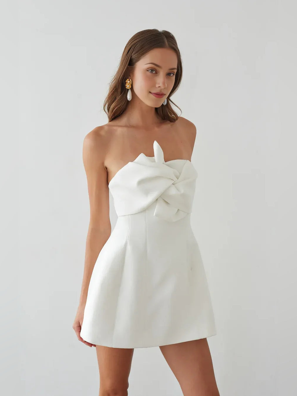 White strapless A-line mini crepe dress with oversized bow detail