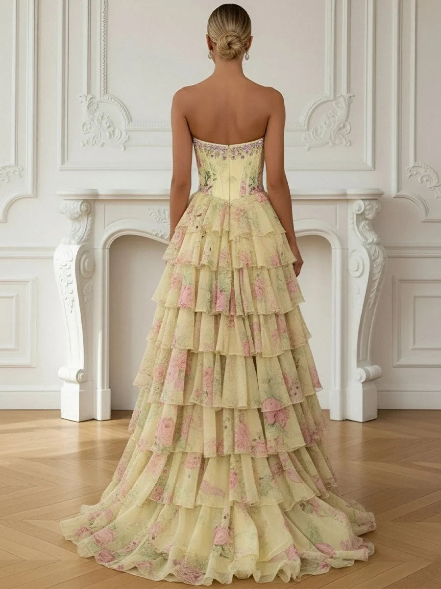 Back view of pale lemon strapless corset prom dress with tiered floral ruffles, floor length