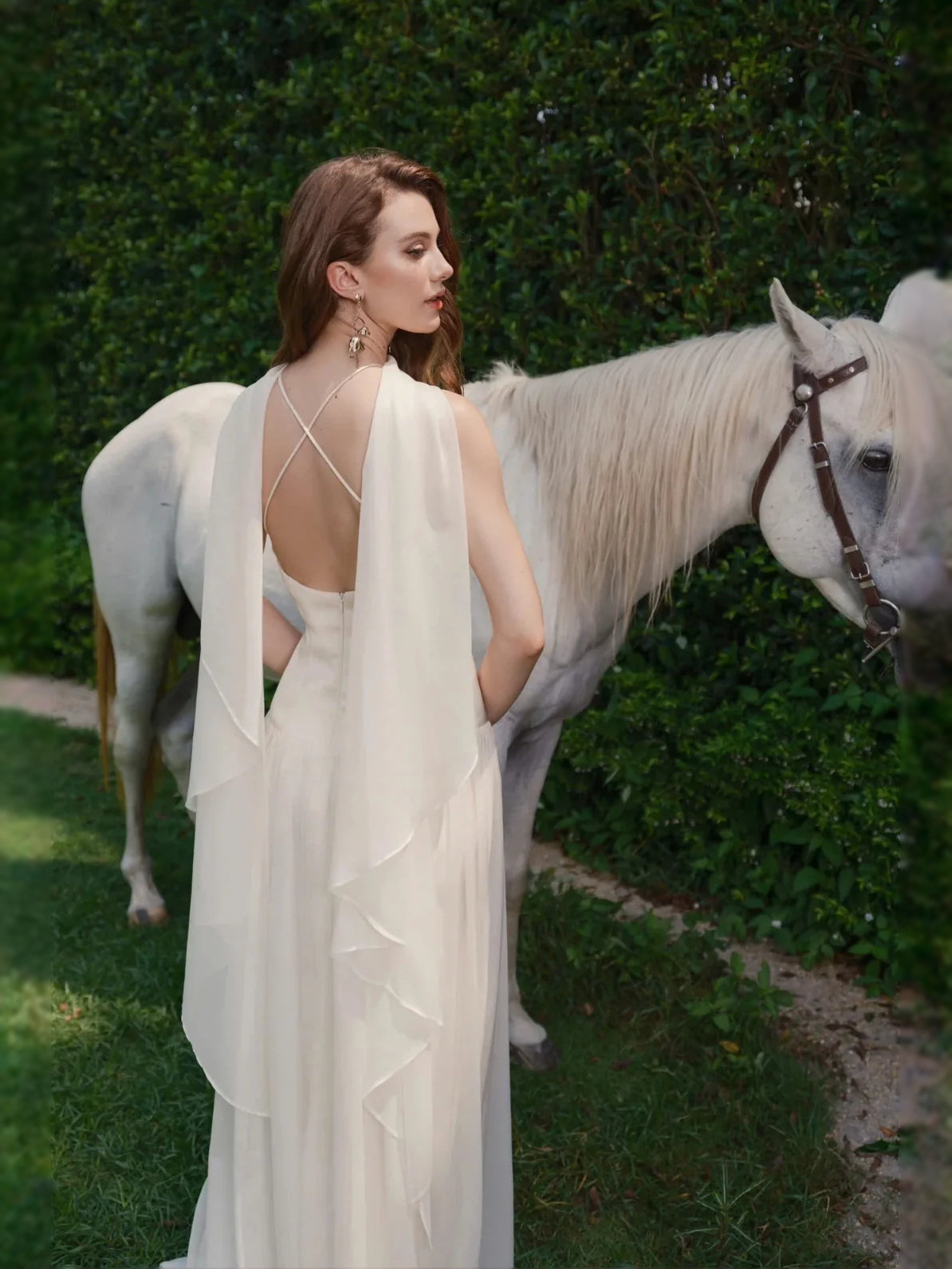 Ivory chiffon halter gown with crisscross back straps and draped, tiered skirt