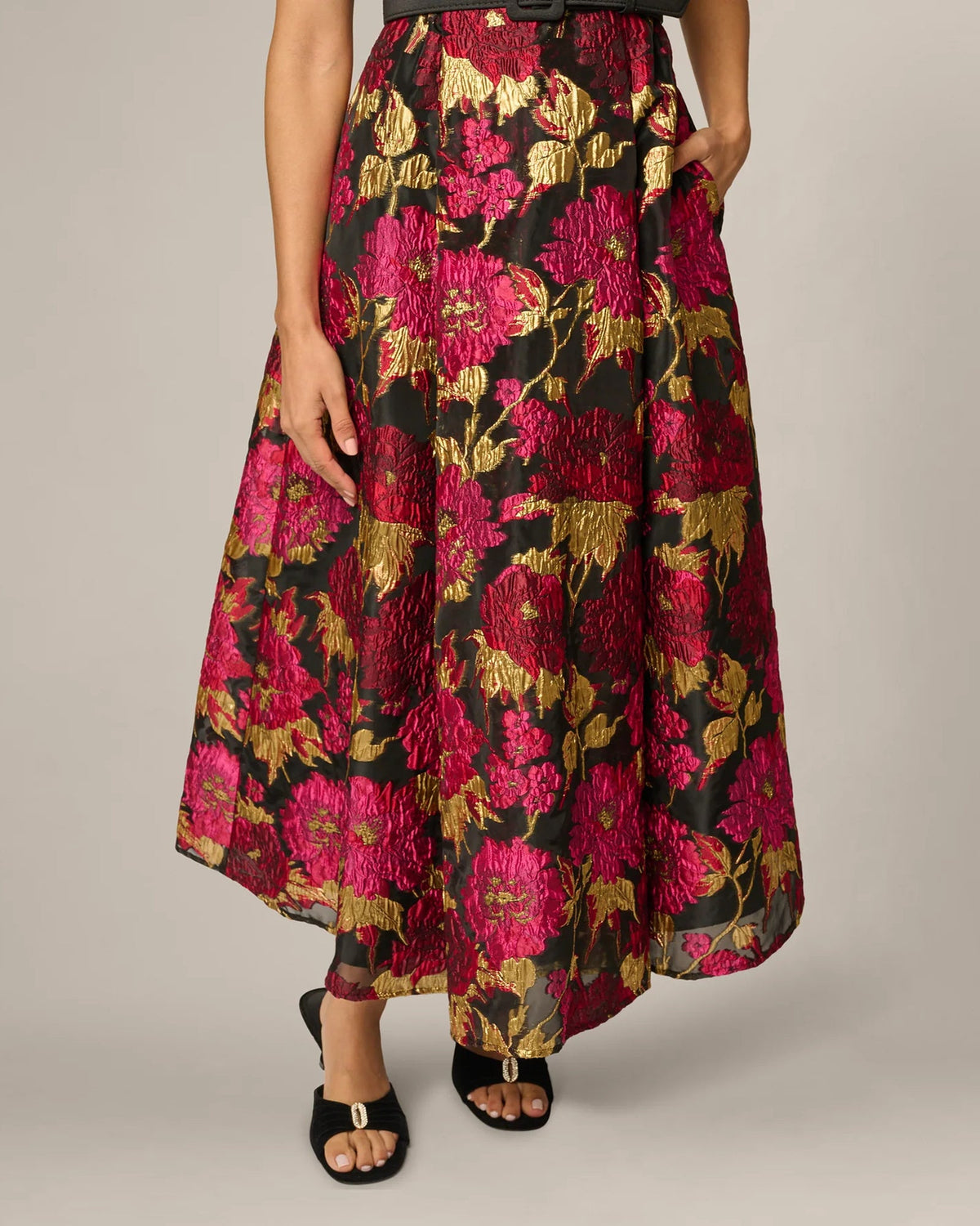 Floral A-line maxi skirt with magenta, black, and gold leaf-like print