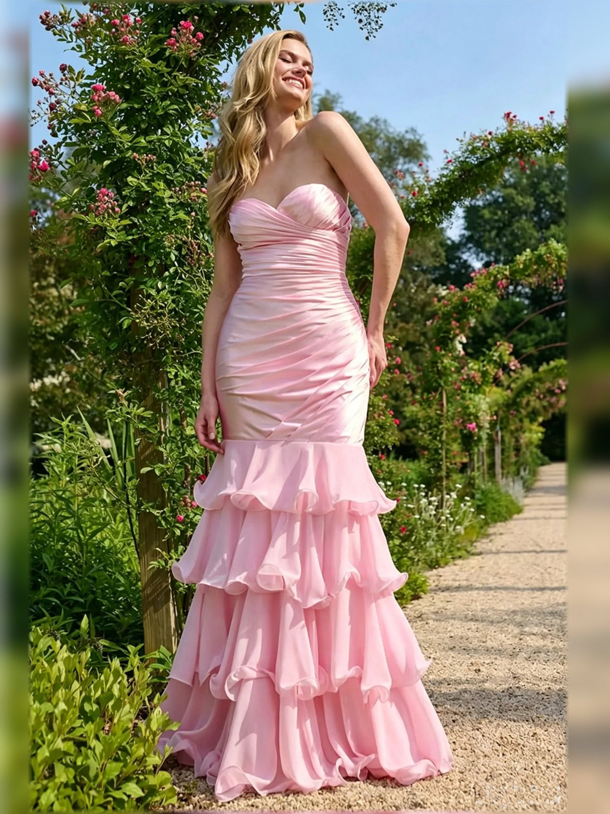 Pink sleeveless sweetheart ruched gown with layered tiered ruffle hem, floor length