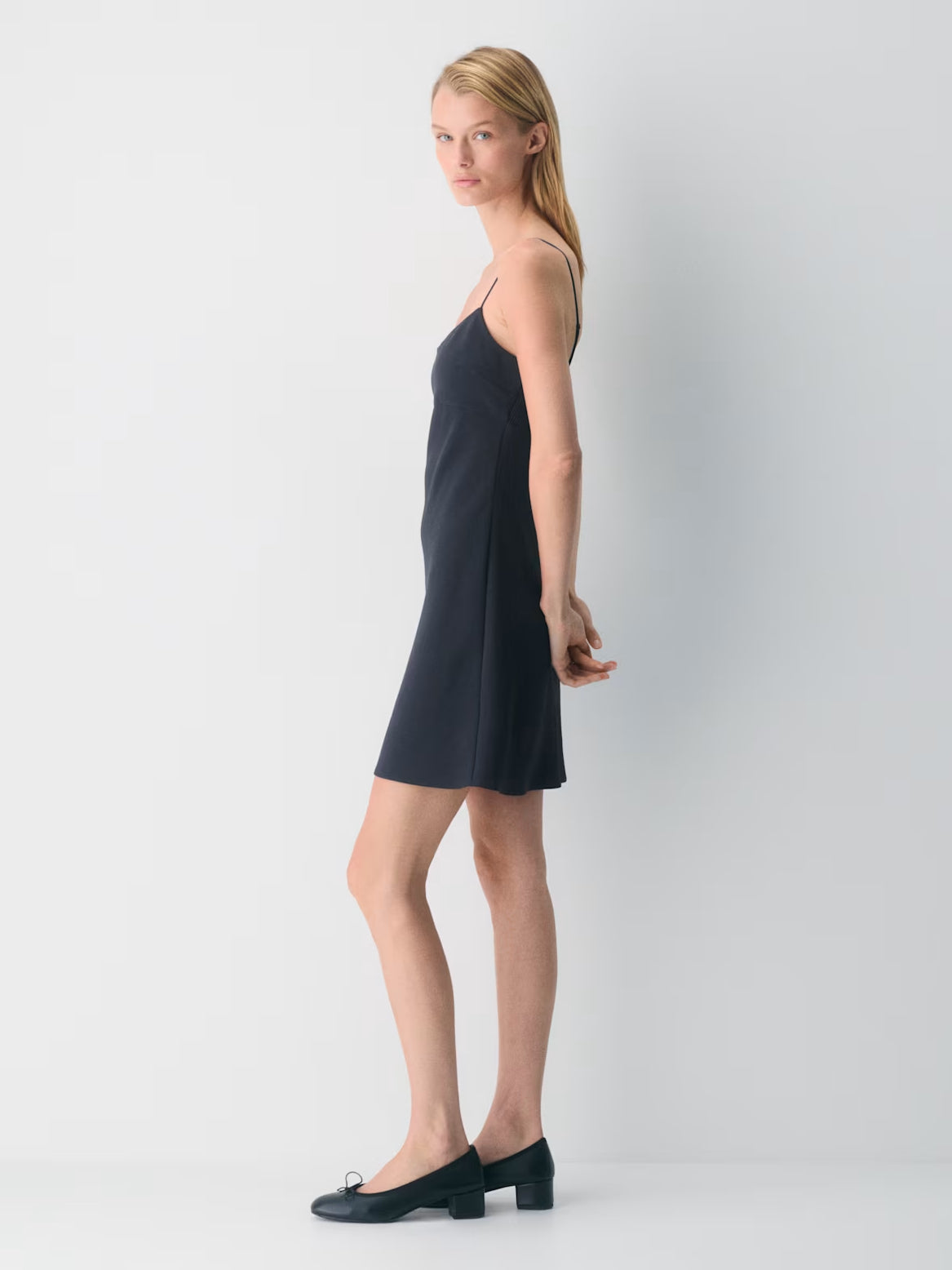 Navy mini crepe dress, side view, spaghetti straps and straight hem